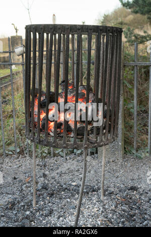 A coal fire within a riveted steel brazier, Beamish Museum, north east England, UK Stock Photo