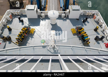 Looking down on a lower deck of a Scottish car ferry at the access ramp and the geometric patterns of the deck machinery Stock Photo