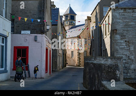 The narrow streets of downtown Lerwick, Shetland Islands,  with stone architecture and cheerful bunting Stock Photo