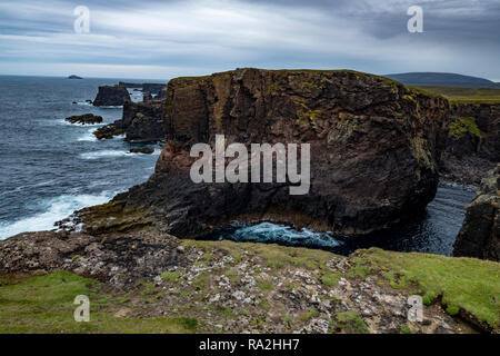 The rocky and wild northern coast of the North Roe district of the Shetland Islands facing the power of the Atlantic Ocean Stock Photo