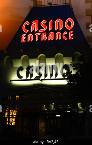 An outside night time view of neon and flood lights for the entrance to the Casino at the Excalibur Hotel and Casino in Las Vegas, NV Stock Photo