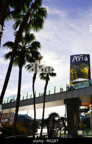 A cropped view of people walking in silhouette over the pedestrian bridge that crosses over the Las Vegas Strip in Las Vegas, NV, near the Aria Hotel  Stock Photo