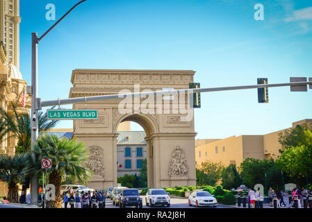 The Arc de Triomphe replica, or the Arch of Triumph, on the Las Vegas strip at Paris Las Vegas Hotel and Casino with traffic and tourists on sidewalks Stock Photo