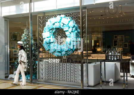 Asian woman walks by the entrance to the luxury store of Tiffany & Co., jewelers inside the Caesars Palace Forum Shops Mall in Las Vegas,  NV Stock Photo