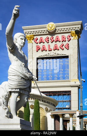 A marble statue of Caesar holding up his hand in front of the entrance to Caesars Palace Hotel and Casino on the Las Vegas Strip in Las Vegas, NV Stock Photo