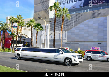 A white Cadillac stretch limousine traveling on the Las Vegas Strip in front of the Linq Hotel and Casino in Las Vegas, NV on a sunny day Stock Photo