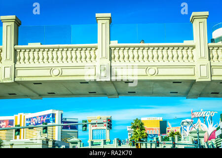 Pedestrian bridge leading from Caesars Resort Hotel and Casino over the Las Vegas strip  with a view of many casinos and hotels in the distance in Las Stock Photo