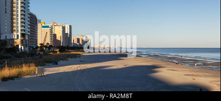 Myrtle Beach, South Carolina, United States - October 29, 2018: Panoramic view of the Sandy Beach at the Atlantic Ocean during a sunny sunset. Stock Photo