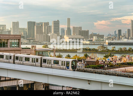 Tokyo Yurikamome Monorail train at Odaiba with the Tokyo Skyline in the background, Japan Stock Photo