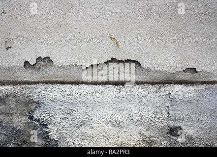 cracked plaster surface on damp exterior wall of old house Stock Photo