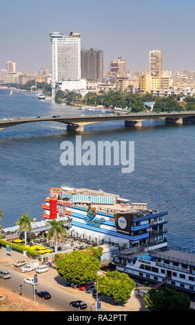 Floating restaurants TGI Fridays, Grand CafŽ, Fish Market on boats moored at Giza on the River Nile, Cairo University Bridge, Grand Nile Tower Hotel Stock Photo