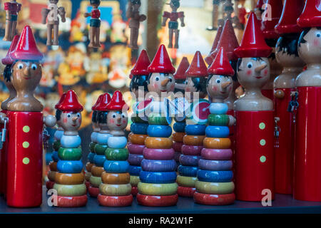 Colored figures in the shape of Pinocchio stacked with increasing dimensions and more and more colorful. Children toy. Stock Photo