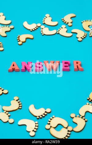 Answer Search Concepts. Concepts search answer. footprints and the word answer on a blue background. vertical photo Stock Photo
