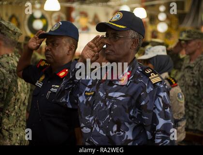 Commander of the Djiboutian Naval Forces Col. Ahamed Daher Djama, right, and commander of the Djiboutian Coast Guard Col. Wais O. Bogoreh, salute the parade of colors during a change of charge ceremony at Camp Lemonnier December 29, 2018 near Djibouti City, Djibouti. Stock Photo