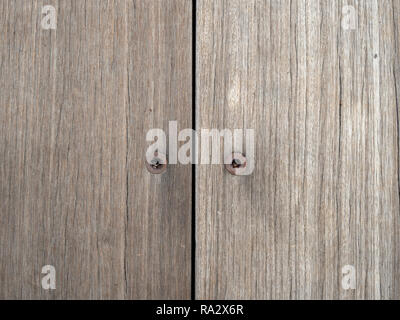 Two rusty hex screws inside wooden boards Stock Photo