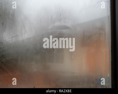 Window in store covered in fog and condensation from the indoors Stock Photo
