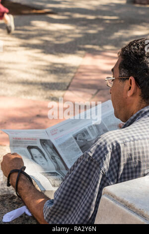 man reading local newspaper in Havana, Cuba, Caribbean Stock Photo