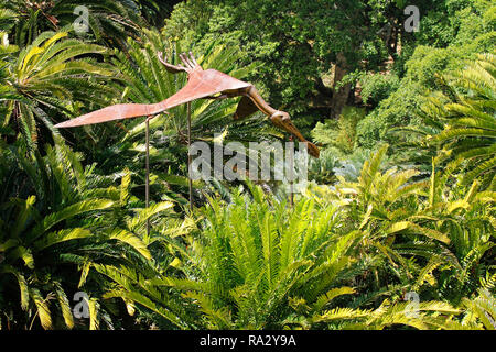 A small portion of the cycad amphitheatre in Kirstenbosch National Botanical Garden in Cape Town with a metal sculpture of a pterodactyl. Stock Photo