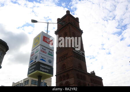 Exterior of Hamilton Square station sign and tower, complete with signage stating 'HAMILTON SQUARE STATION - FREQUENT ELECTRIC TRAINS' Stock Photo