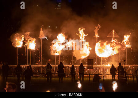 Edinburgh, Scotland, UK. 30th December, 2018. Wicker artwork is set on fire in Holyrood Park as a finale to the Spectacular Torchlight Procession through the streets of the Capital which is the opening event to start the city's New Year celebrations. Torchbearers walked down the Royal Mile and gathered in Holyrood Park to arrange the outline of the map of Scotland with fire. The procession was lead by PyroCeltica and Harbingers Drum Crew. Credit: Skully/Alamy Live News Stock Photo