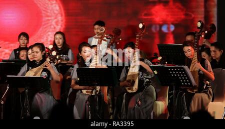 Kathmandu, Nepal. 30th Dec, 2018. Chinese artists perform during a musical concert to mark the New Year in Kathmandu, Nepal, Dec. 30, 2018. A special concert by China's Guizhou Provincial Qian Opera Theater was held here on Sunday to celebrate the upcoming New Year 2019 and to enhance Sino-Nepali cultural exchanges. The concert was featured a range of opera theater performances, from folk to modern, by young Chinese musicians. Credit: Sunil Sharma/Xinhua/Alamy Live News Stock Photo