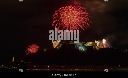 Stirling Castle, Stirling, UK - 1st January 2019. Bringing in the new year with a bang, Firework displays with music light up the night sky over Stirling Castle and the Wallace Monument on Hogmanay to bring in the new year. Credit: Colin Fisher/Alamy Live News Stock Photo