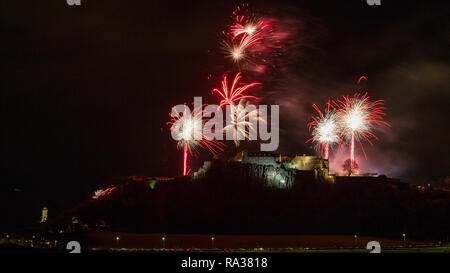 Stirling Castle, Stirling, UK - 1st January 2019. Bringing in the new year with a bang, Firework displays with music light up the night sky over Stirling Castle and the Wallace Monument on Hogmanay to bring in the new year. Credit: Colin Fisher/Alamy Live News Stock Photo