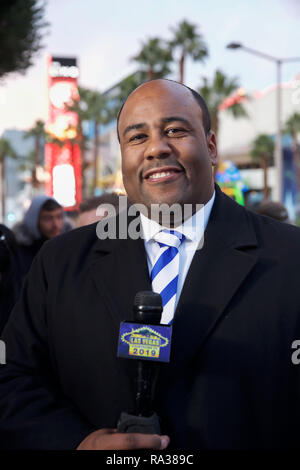 Las Vegas, Nevada, USA. 31st Dec, 2018. News Reader  Anthony Bailey on the strip as New Year's Eve preparations get underway in Las Vegas, Nevada, despite blue skies there were snow flurries too. Credit: Keith Larby/Alamy Live News Stock Photo