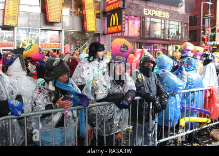 New York, New York, USA. 1st Jan, 2019. People are seen gathered at the Times Square during the New Year's Eve celebrations.Despite all day rain, More than 2 million people participate at the New Year's Eve celebrations at the Times Square. Credit: Ryan Rahman/SOPA Images/ZUMA Wire/Alamy Live News Stock Photo