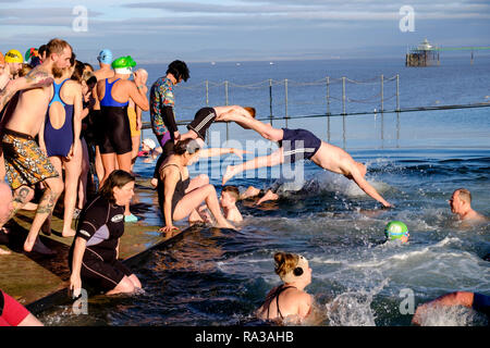 Clevedon, Somerset, UK. 1st Jan 2019. A bracing dip in the Marine Lake Clevedon is a popular way of seeing in the new Year. The water temperature was a chill 6 degrees C. Wet suits were optional.  Credit: Mr Standfast/Alamy Live News Stock Photo