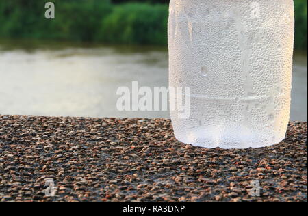 plastic water bottle cool on the stone floor in public park background Stock Photo