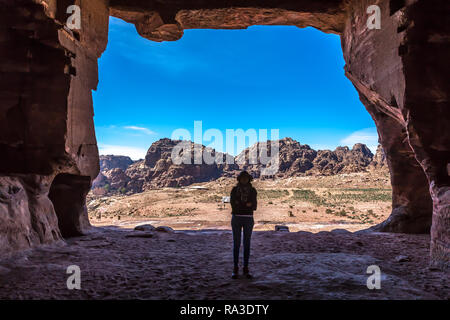 Young woman inside a temple in Petra Heritage Site in Jordan Stock Photo