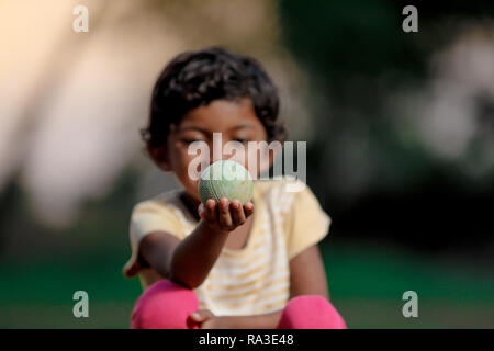 indian girl child playing with ball Stock Photo