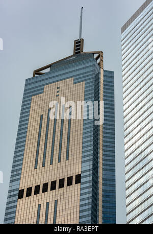 The contrasting facades of Central Plaza and Immigration Tower rise over Harbour Road in Hong Kong's Wan Chai district. Stock Photo