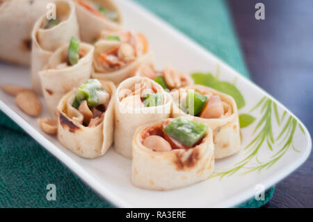 Sushi-Style Wraps with chicken pepperoni, vegetables and nuts. Healthy snacks. Stock Photo
