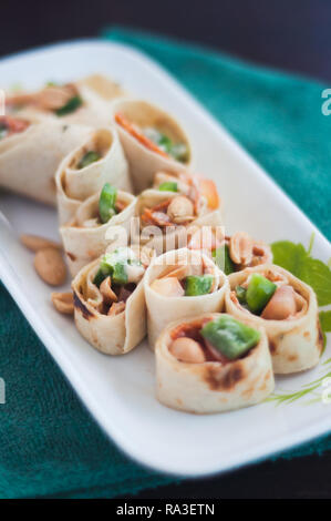 Sushi-Style Wraps with chicken pepperoni, vegetables and nuts. Healthy snacks. Stock Photo