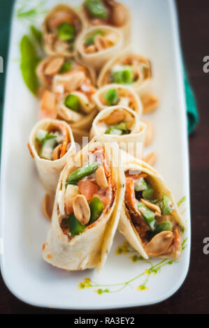 Sushi-Style Wraps with chicken pepperoni, vegetables and nuts. Healthy snacks. Stock Photo