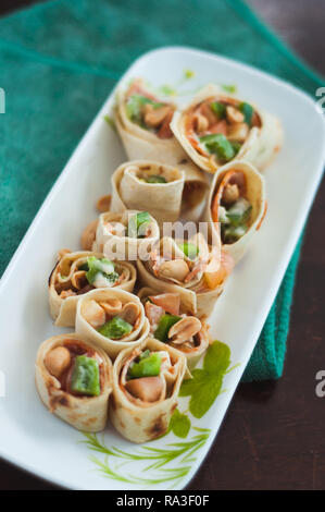 Sushi-Style Wraps with chicken pepperoni, vegetables and nuts. Healthy snacks. Stock Photo