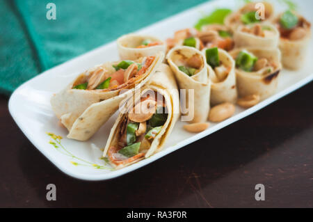 Sushi-Style Wraps with chicken pepperoni, vegetables and nuts. Healthy snacks. Stock Photo