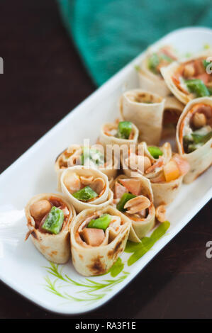 Sushi-Style Wraps with chicken pepperoni, vegetables and nuts. Healthy snacks. Stock Photo