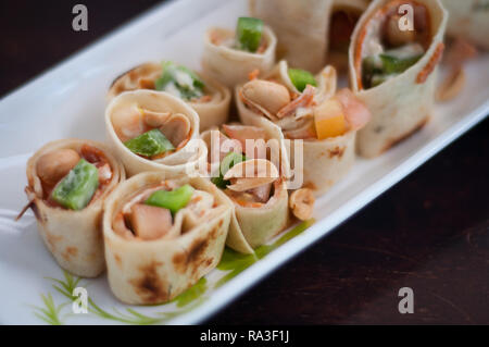 Sushi-Style Wraps with chicken pepperoni, vegetables and nuts. Healthy snacks. Stock Photo