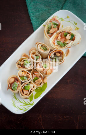 Sushi-Style Wraps with chicken pepperoni, vegetables and nuts. Healthy snacks. Stock Photo
