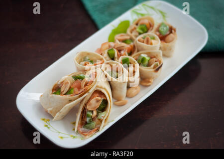 Sushi-Style Wraps with chicken pepperoni, vegetables and nuts. Healthy snacks. Stock Photo