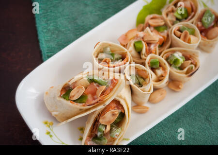 Sushi-Style Wraps with chicken pepperoni, vegetables and nuts. Healthy snacks. Stock Photo