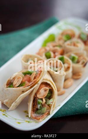 Sushi-Style Wraps with chicken pepperoni, vegetables and nuts. Healthy snacks. Stock Photo