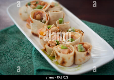Sushi-Style Wraps with chicken pepperoni, vegetables and nuts. Healthy snacks. Stock Photo