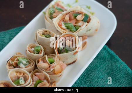 Sushi-Style Wraps with chicken pepperoni, vegetables and nuts. Healthy snacks. Stock Photo