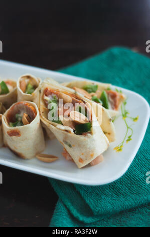 Sushi-Style Wraps with chicken pepperoni, vegetables and nuts. Healthy snacks. Stock Photo