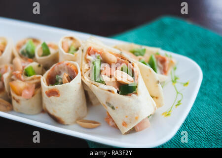 Sushi-Style Wraps with chicken pepperoni, vegetables and nuts. Healthy snacks. Stock Photo