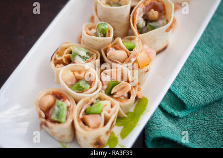 Sushi-Style Wraps with chicken pepperoni, vegetables and nuts. Healthy snacks. Stock Photo
